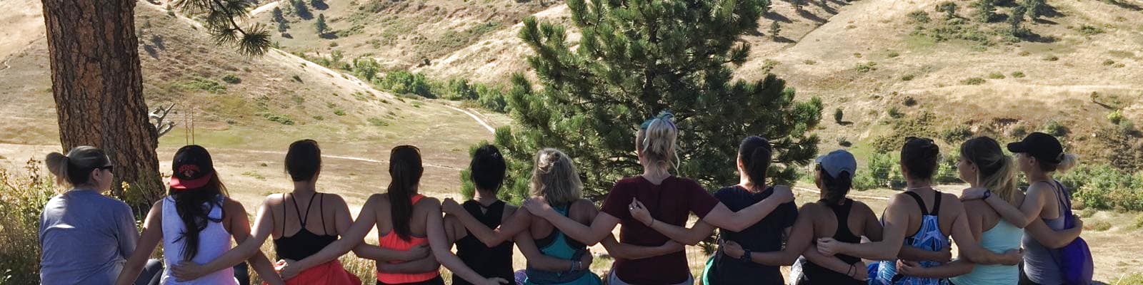 women from the rose house hugs