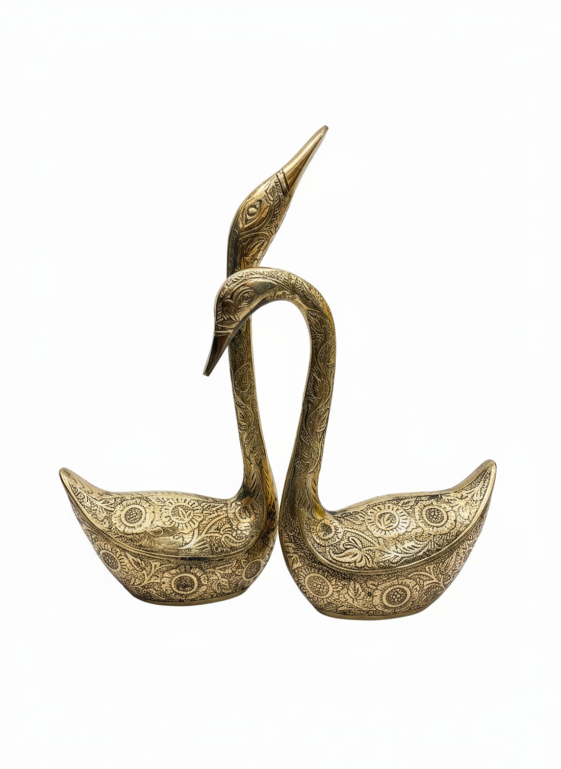 Pair of handcrafted brass swan figurines with intricate floral engravings and antique finish for home interior decoration.