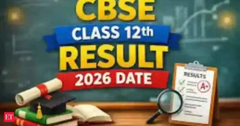Students looking at a laptop screen, checking exam results.