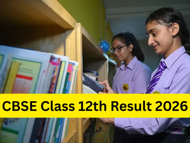 Students checking CBSE Class 12th results on a laptop.