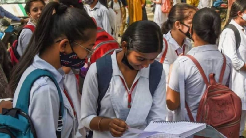 Students looking at a computer screen for their board exam results