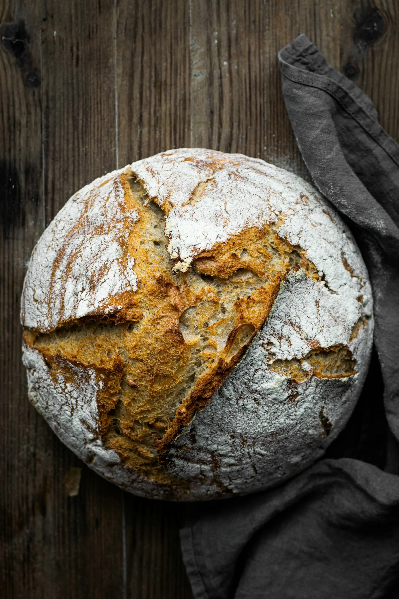 Aerated bread dough with visible fermentation bubbles beside a firmer, less-risen piece of dough.