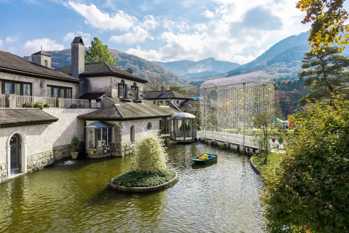 Venetian-style glass museum in Hakone featuring sparkling crystal arches, elegant European gardens, seasonal flowers, and historic Murano glass artworks surrounded by mountain scenery.