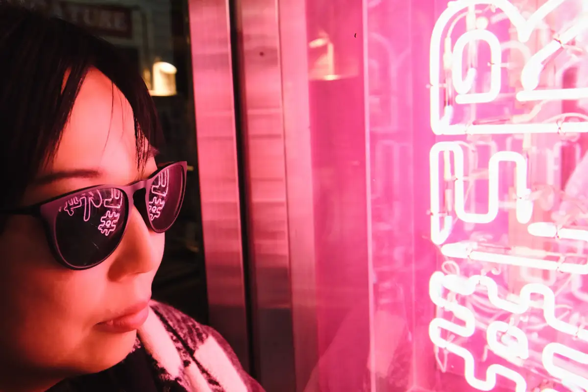 Neon lights reflect on sunglasses in Harajuku, Tokyo