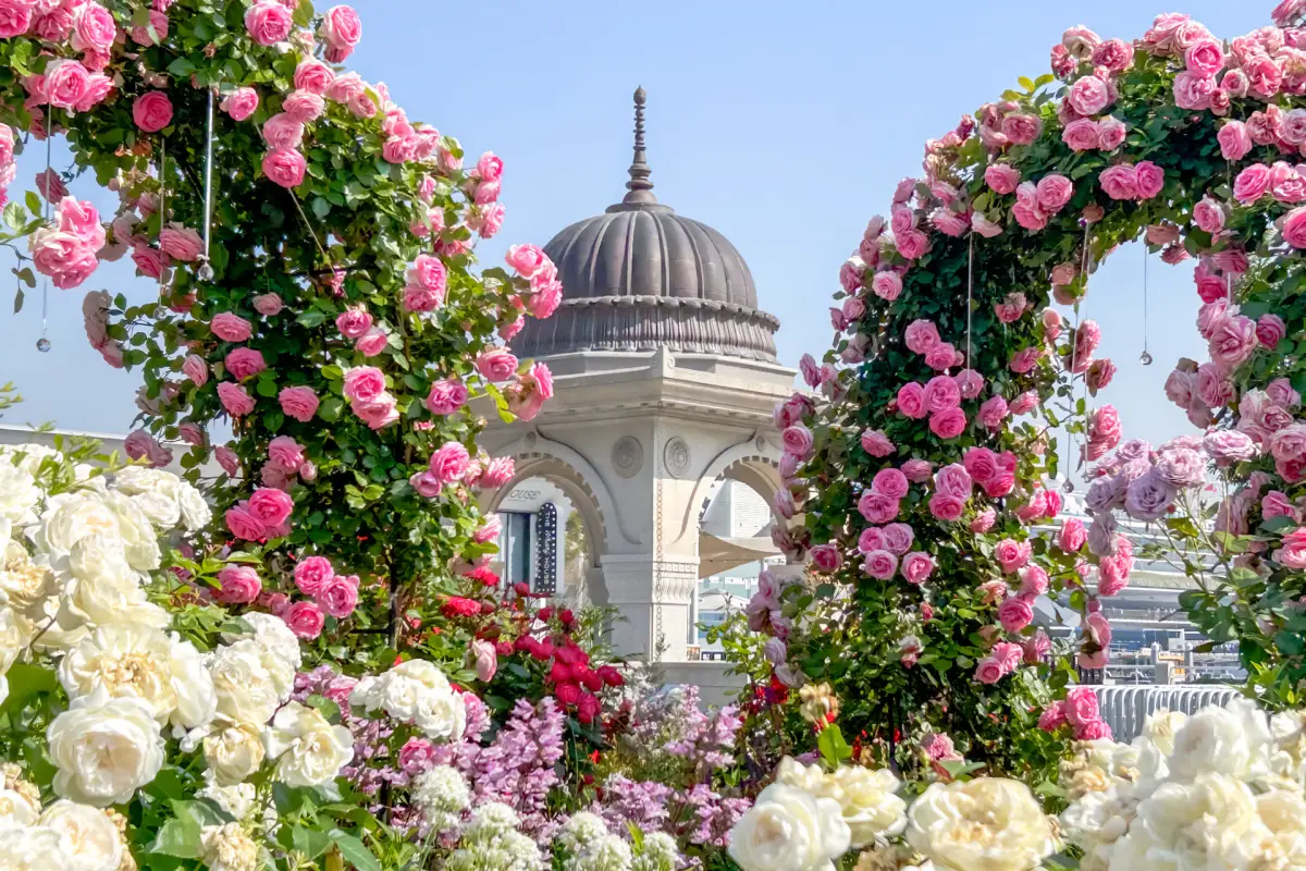 Elegant floral arrangements, garden paths, and lush greenery throughout the botanical garden
