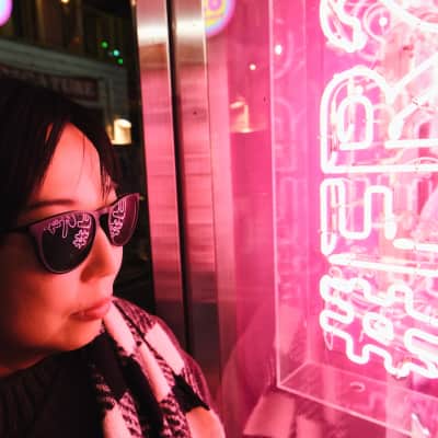 Neon lights reflect on sunglasses in Harajuku, Japan