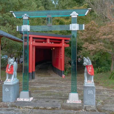 Transparent crystal torii gates and traditional red torii at a Japanese Inari shrine