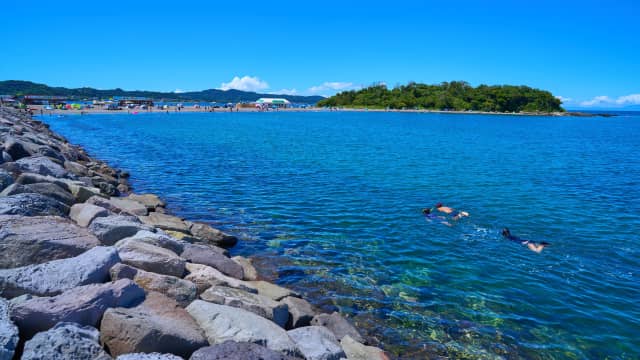 Clear turquoise water and sandy shore at Okinoshima Beach in Tateyama