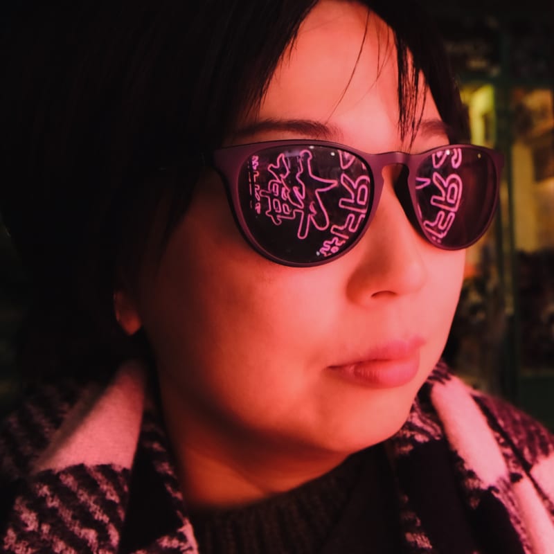 Neon lights reflect on sunglasses in Harajuku, Japan