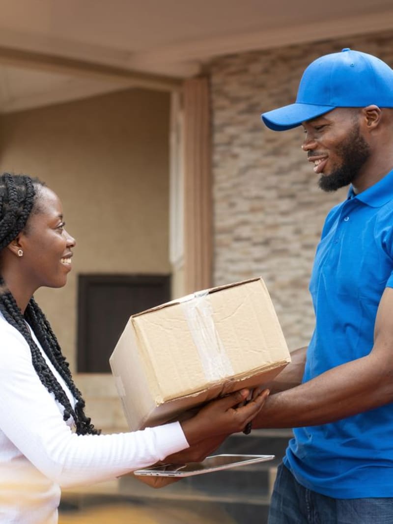Customer receiving a package from an Obana driver