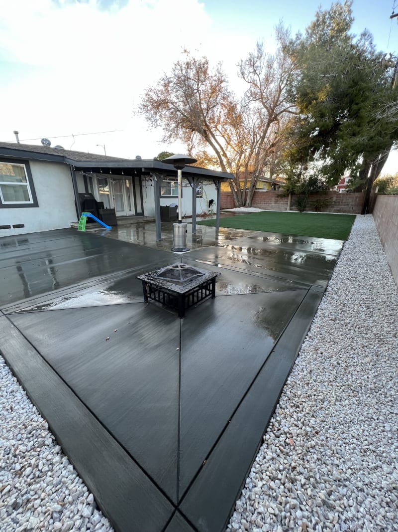 Broom-finish concrete patio with diagonal joints and a fire pit
