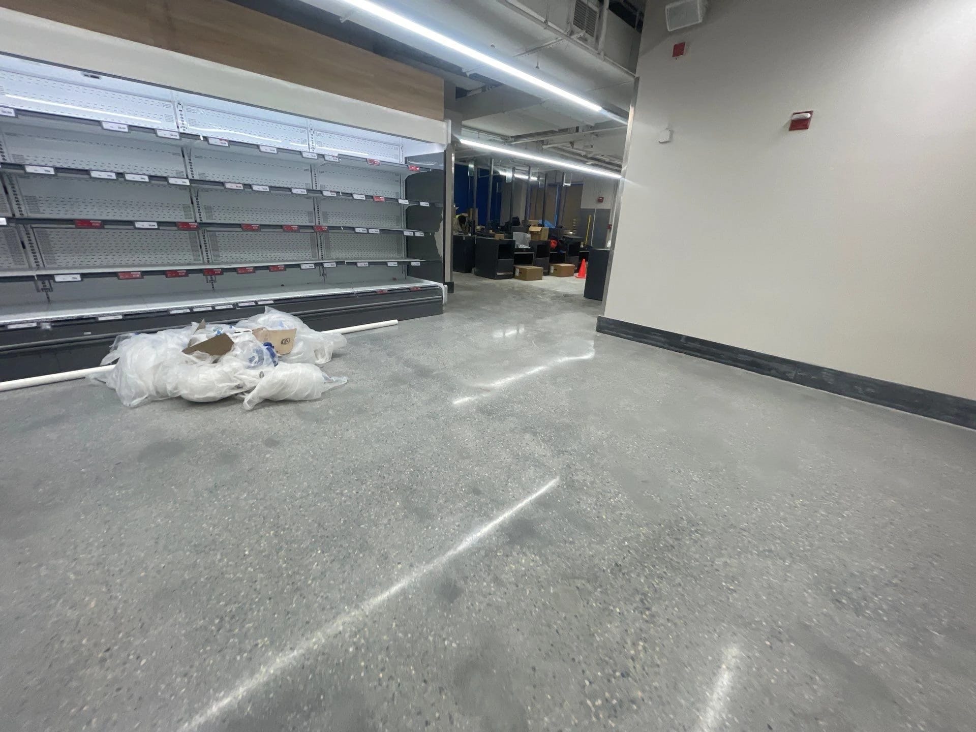 Finished concrete floor along the retail display wall