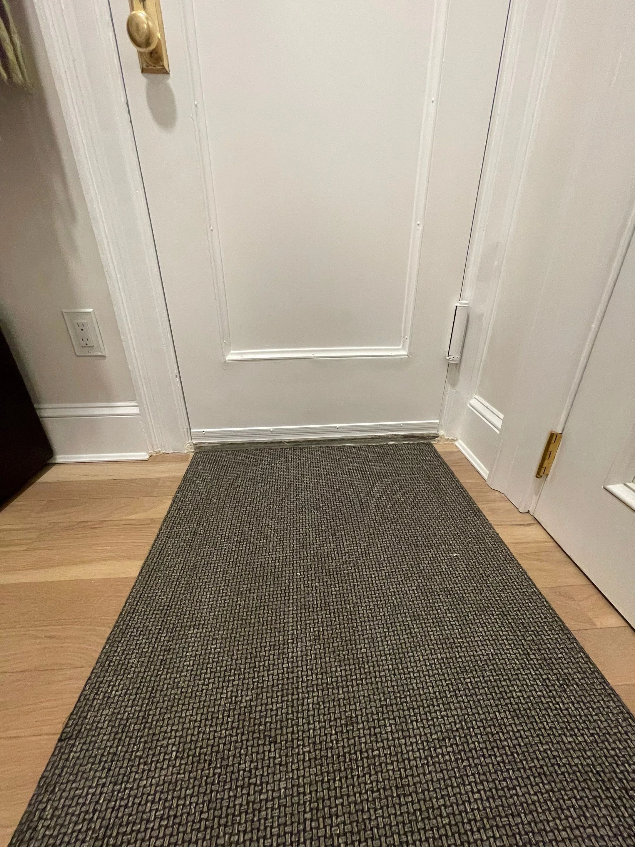 Interior door and hardwood floor in the renovated apartment