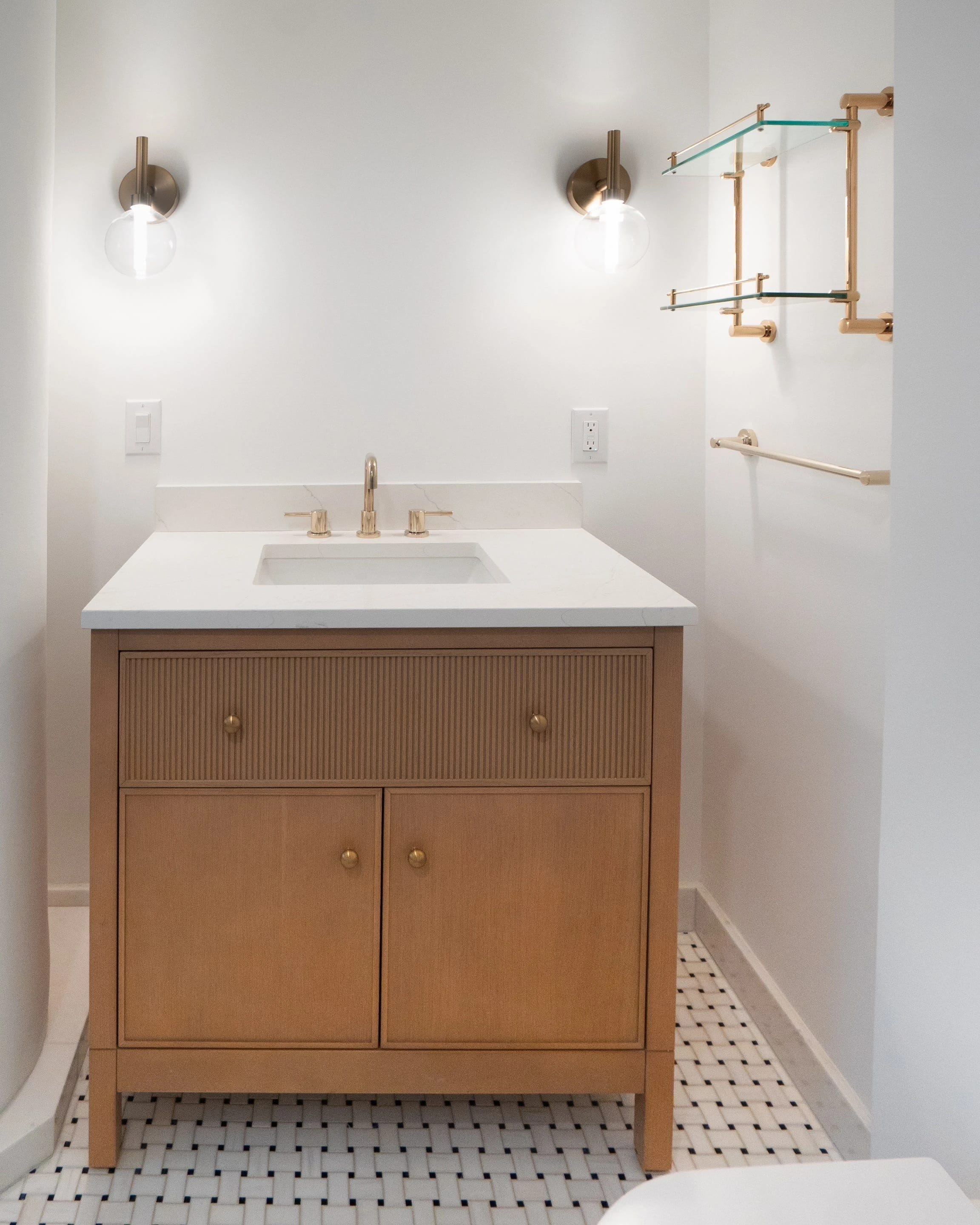 Tribeca bathroom vanity with brass sconces