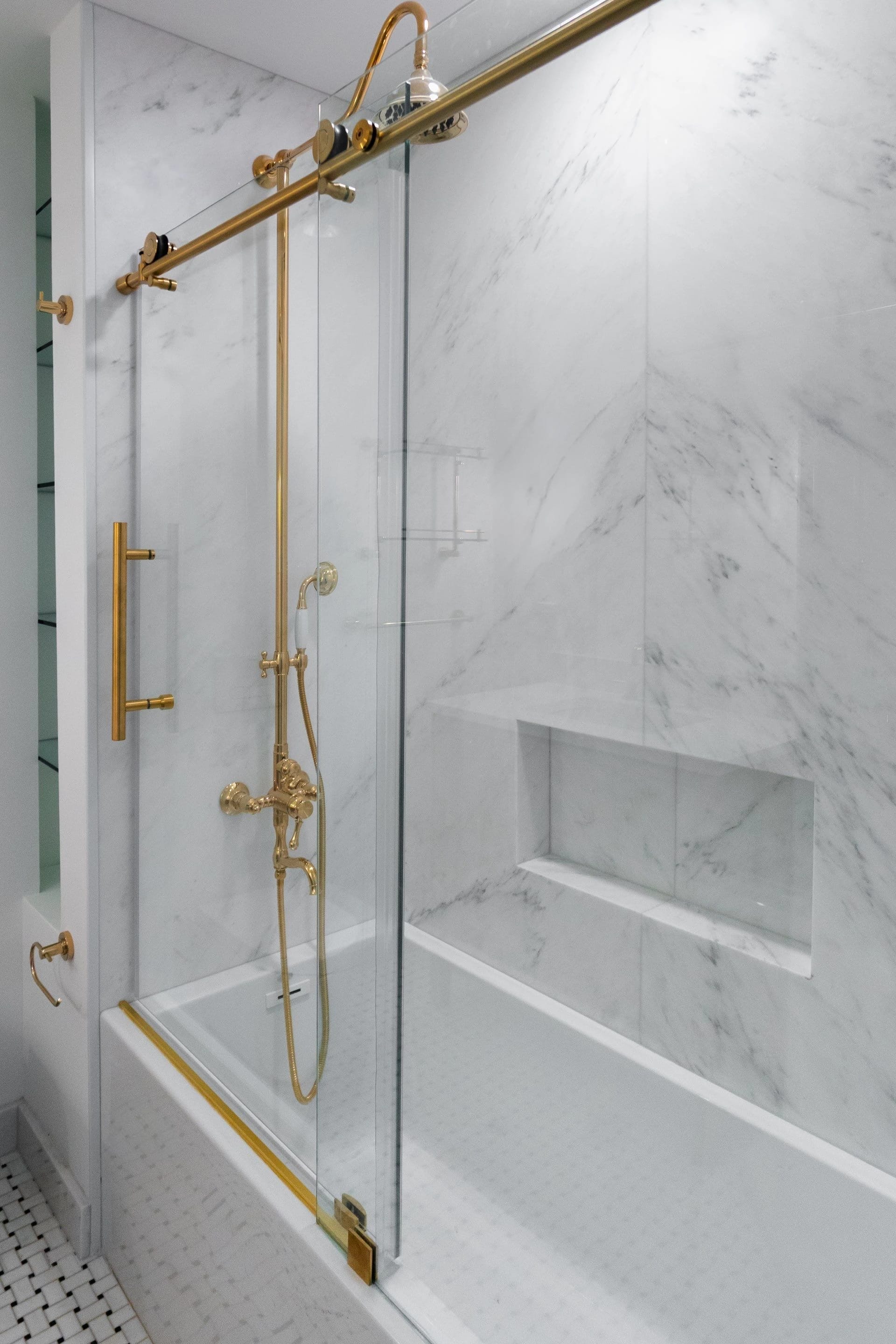 Brass-framed shower door in the renovated bathroom