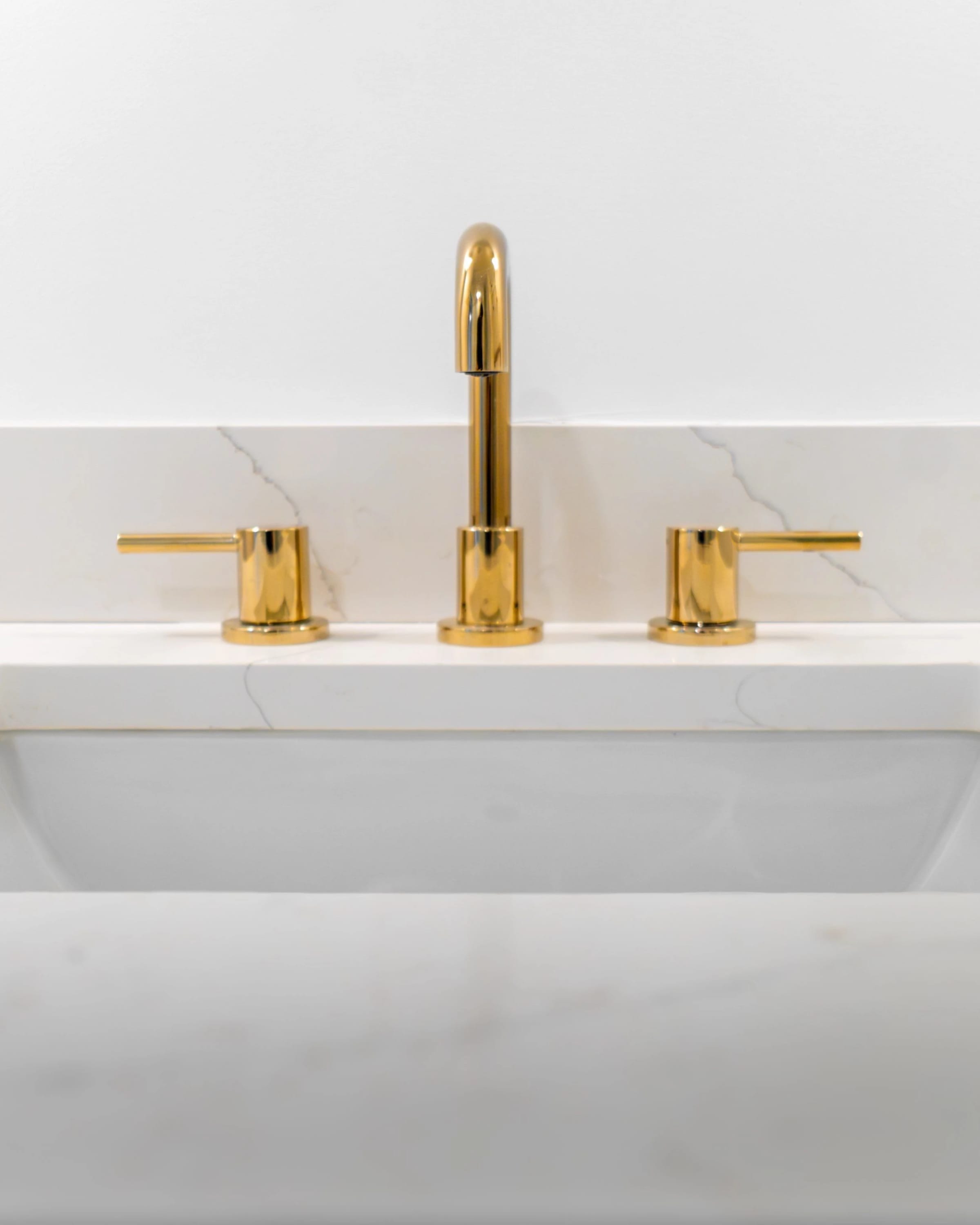 Brass faucet detail in the renovated bathroom