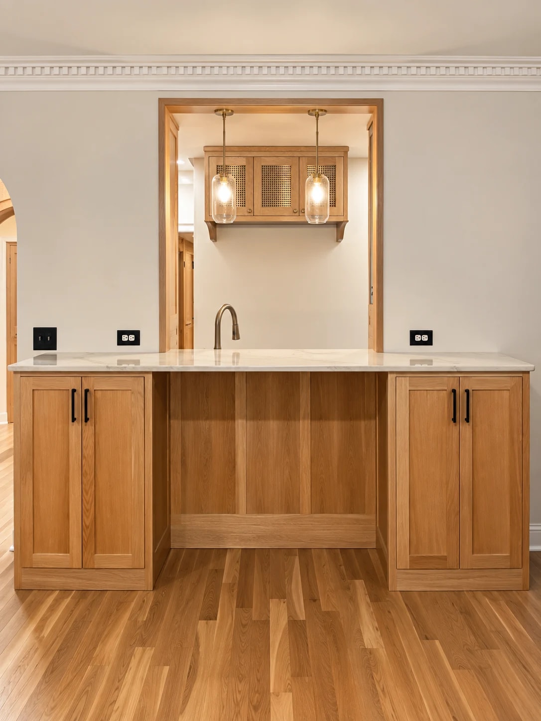 Custom white oak millwork from adjoining living room with quartzite bow shaped countertop