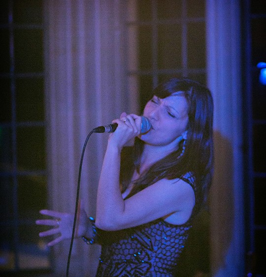 photo of nina singing at an evening wedding reception