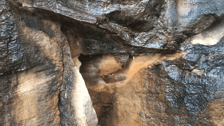 a short animated photograph that shows water dripping on a section of rocks