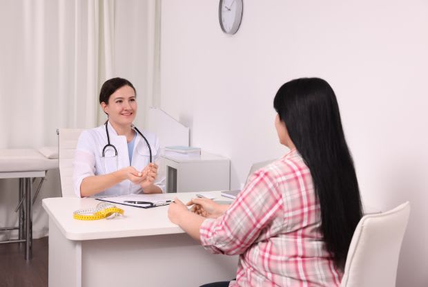 overweight woman talking to a doctor