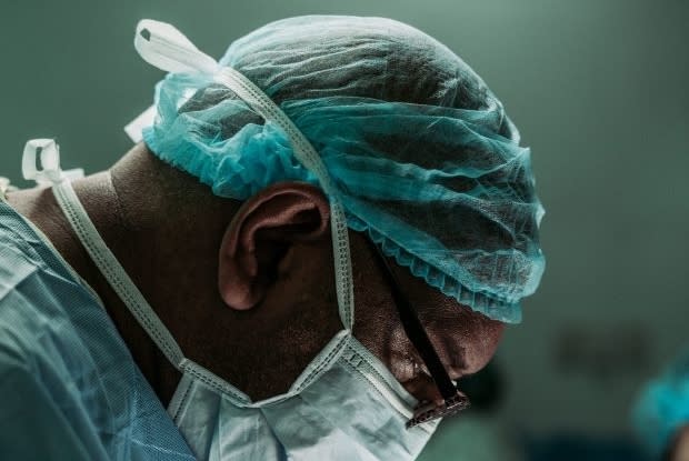 a doctor wearing a mask in the procedure room