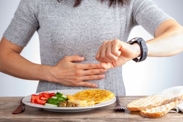 a woman checking the time before eating