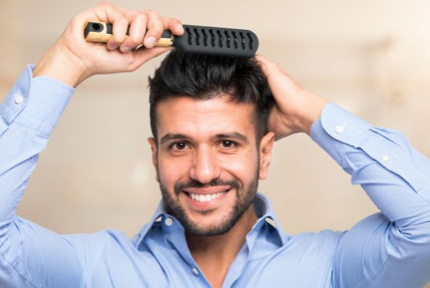 a happy man combing his hair