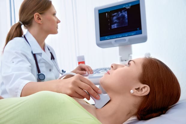 a doctor examining a patient’s thyroid glands