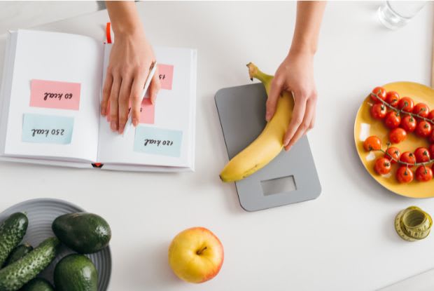 woman weighing a banana