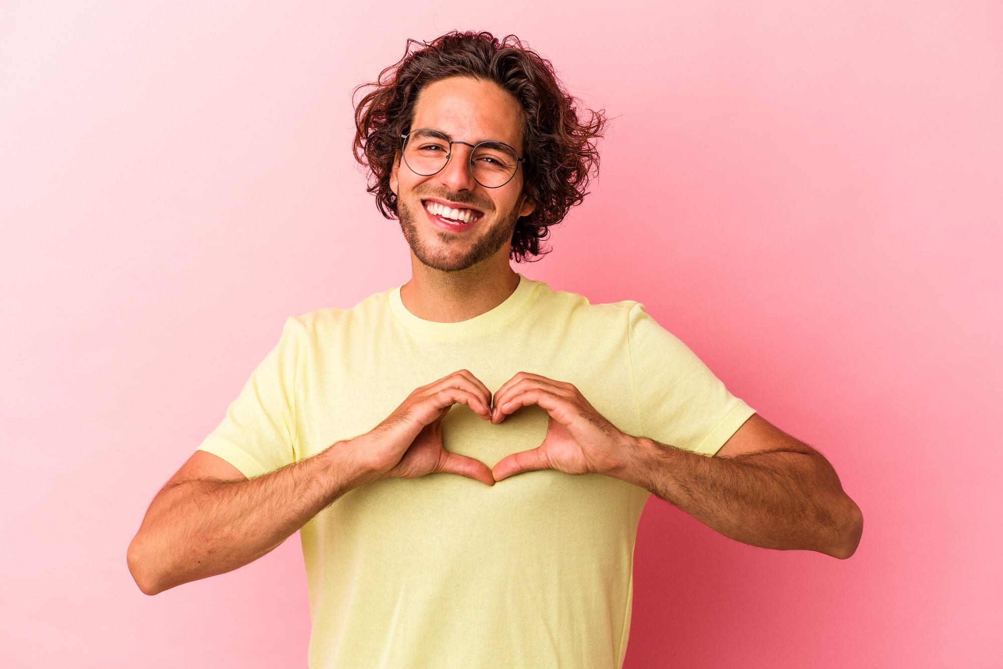 a man making a heart shape with his hands