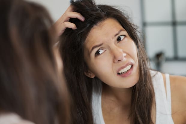 a woman experiencing an itchy scalp