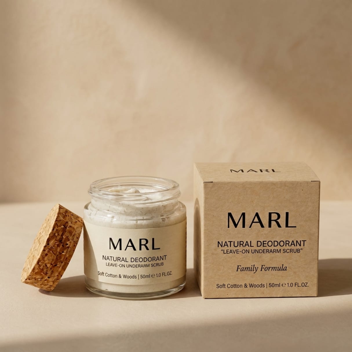 Open jar of MARL Natural Deodorant with cork lid beside its kraft paper box