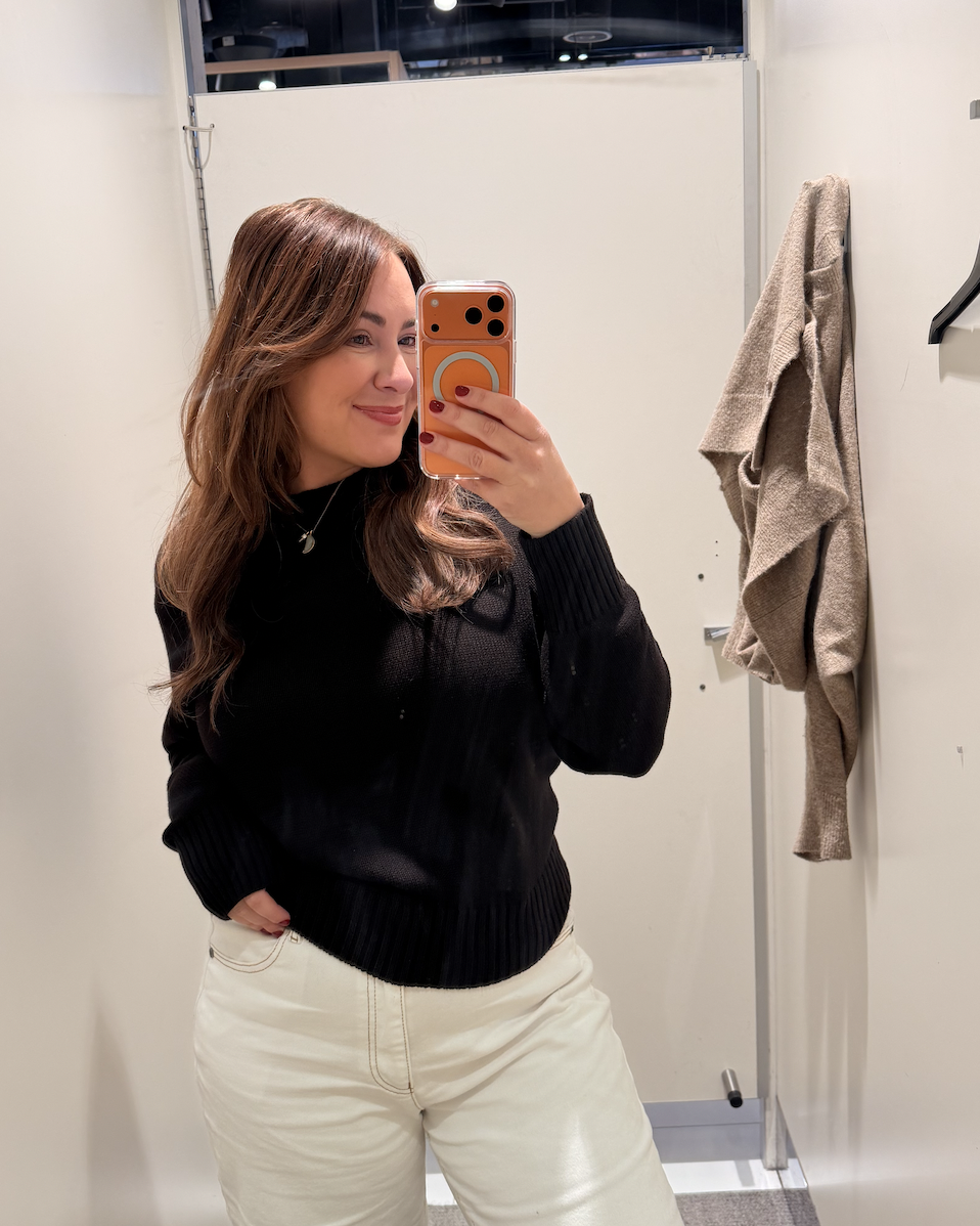Sarah styling outfits in a clothing store