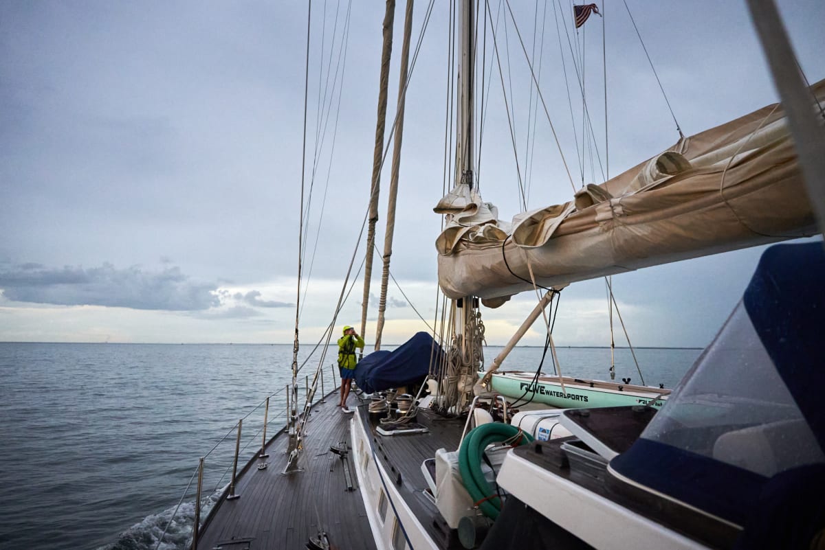 The deck of the expedition ship under sail, open water ahead