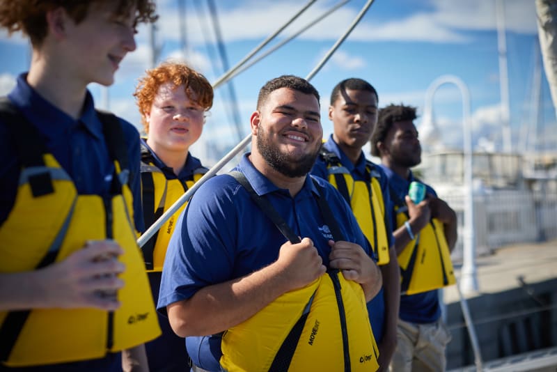 Students in life jackets on the dock
