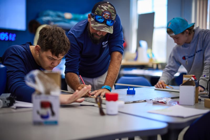 A teacher helping students plan a project