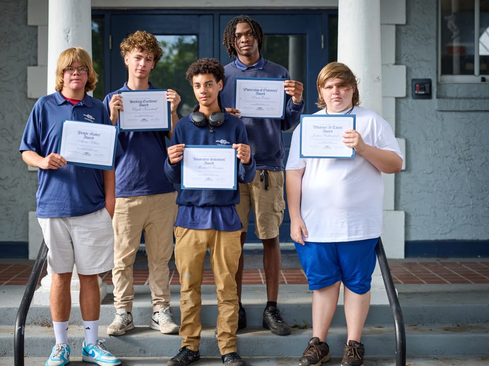 Students proudly display their awards during the Term 4 Awards ceremony.