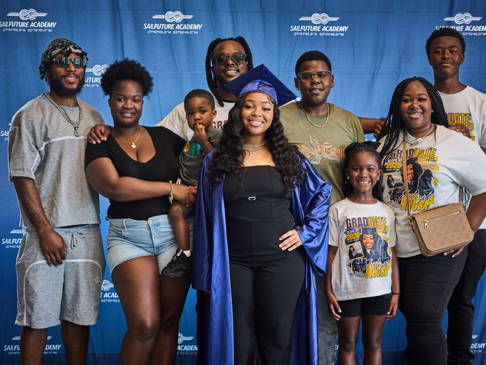 A graduate celebrates the Class of 2026 milestone surrounded by family and friends.