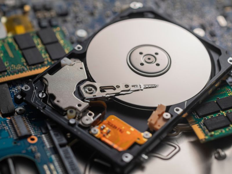 Open hard drive with internal parts exposed, highlighting the data recovery process.
