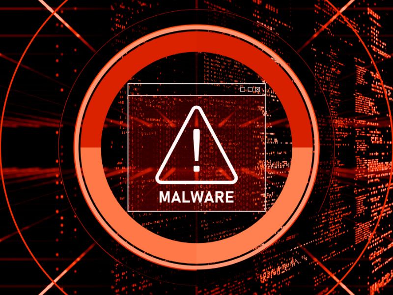 Red warning sign with the word “Malware” on a digital screen background