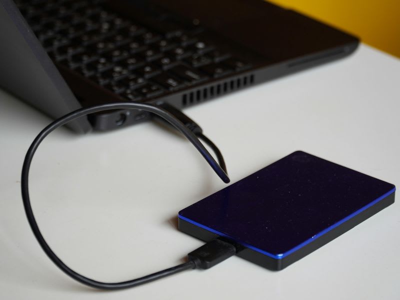 External hard drive connected to a Windows laptop, demonstrating how to back up a PC