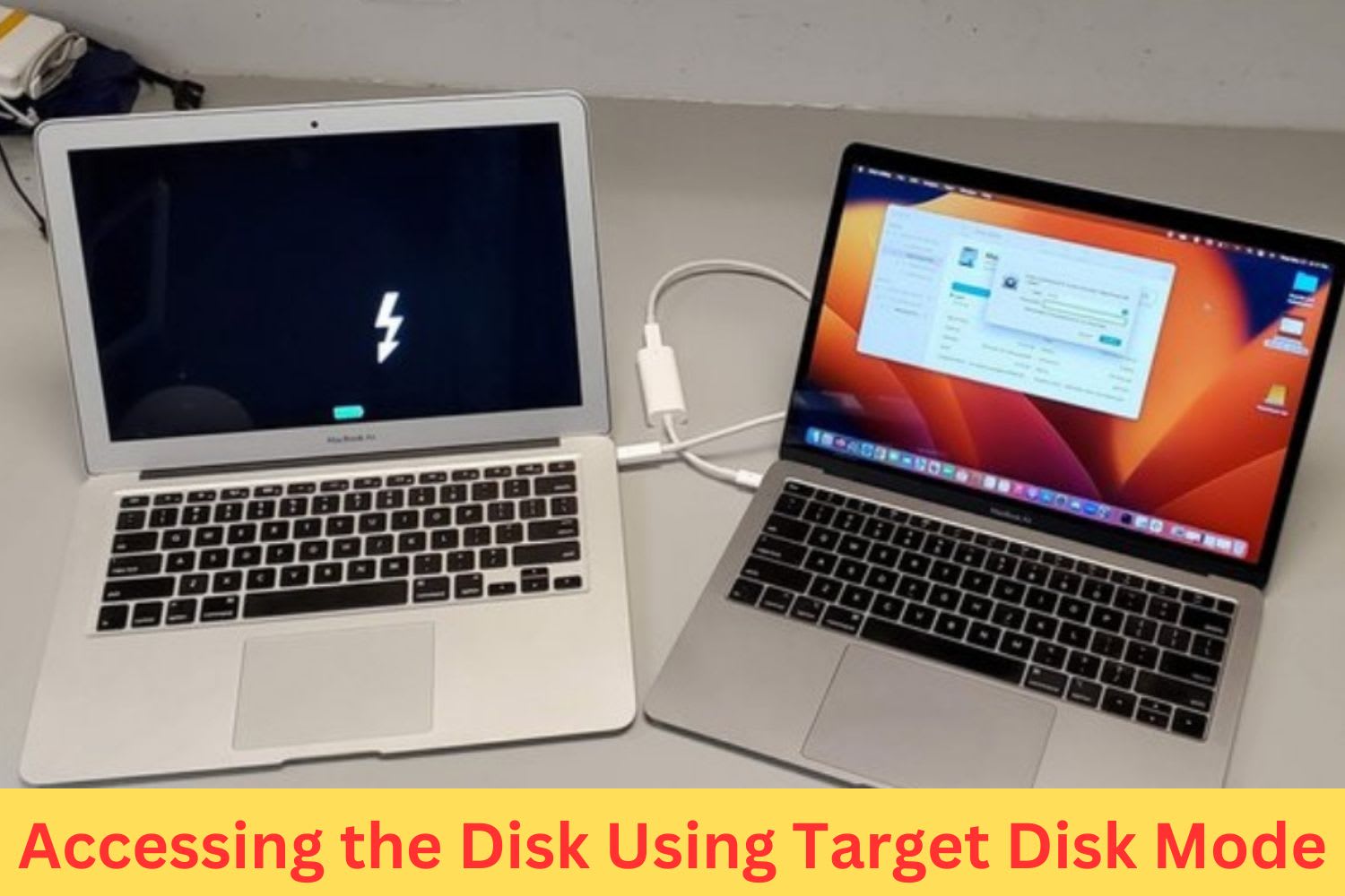 Two MacBooks connected via cable using Target Disk Mode to transfer data from one Mac to another