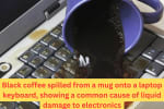 Close-up of black coffee being spilled from a mug onto a laptop keyboard, showing a common cause of liquid damage to electronics.