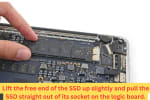Close-up of a technician lifting the SSD from a MacBook logic board during solid-state drive replacement or upgrade