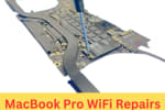 Technician using a screwdriver to repair or replace the WiFi module on a MacBook Pro logic board