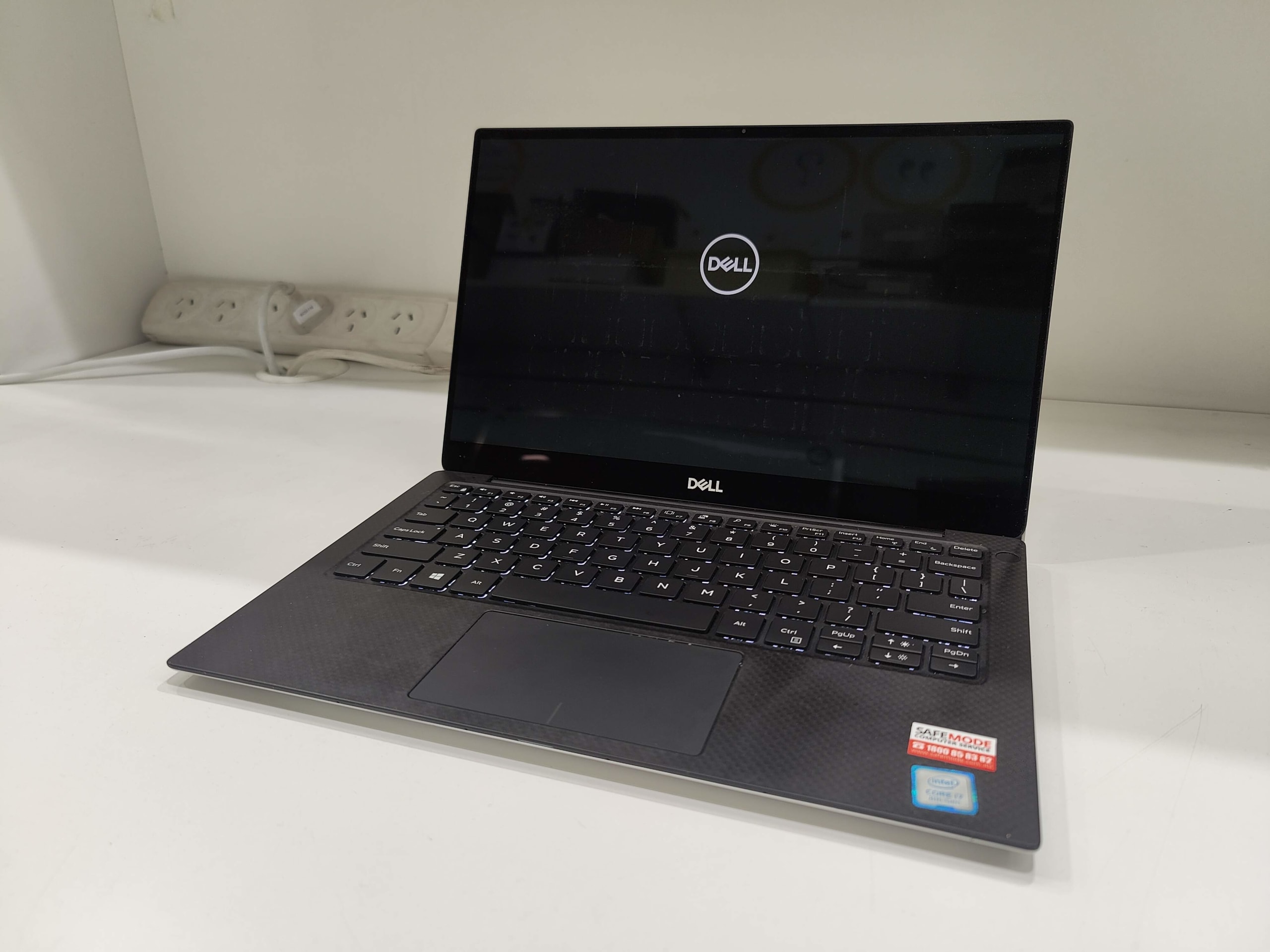 Repaired Dell XPS 13 laptop successfully booting with new genuine keyboard installed.