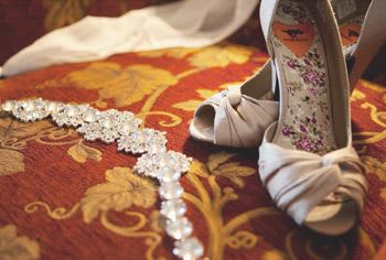 Close-up of bride's shoes and jewelry