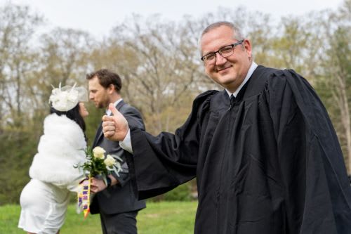 Wedding minister congratulating just married couple