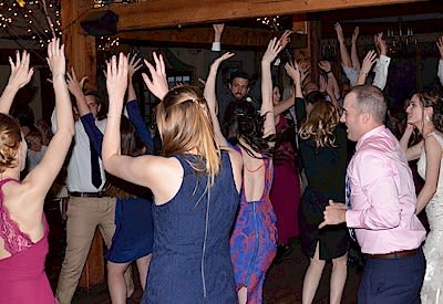 wedding party and guests having lots of fun dancing