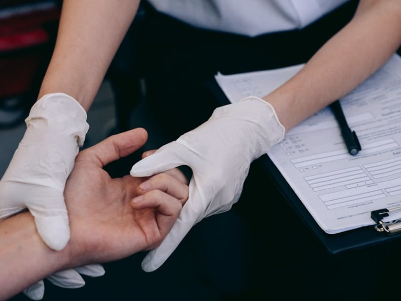 Healthcare professional inspecting radiation protection gloves for damage